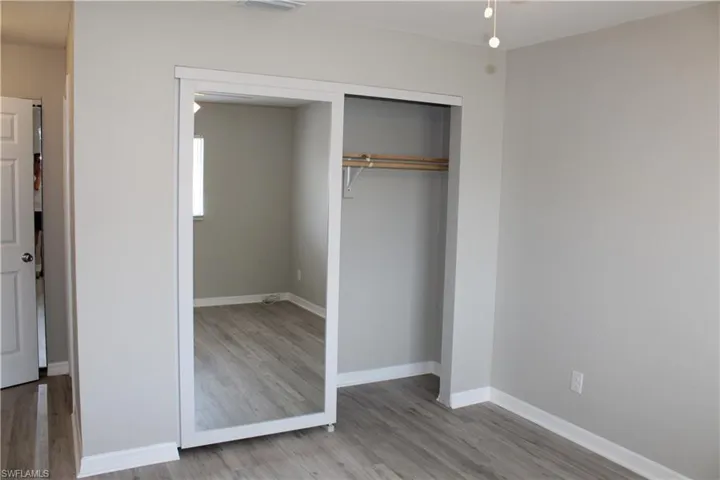 Unfurnished bedroom featuring hardwood / wood-style flooring and a closet