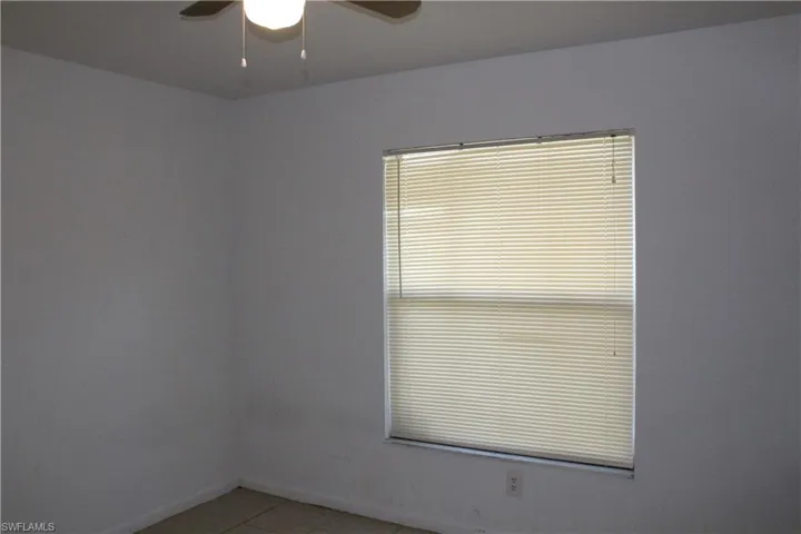 Spare room with tile patterned flooring and ceiling fan