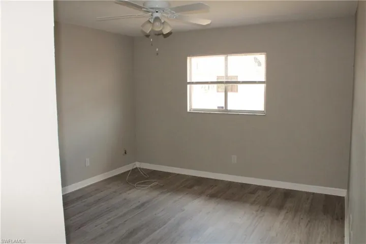 Unfurnished room with hardwood / wood-style floors and ceiling fan