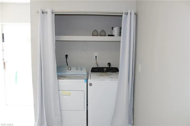Laundry area featuring washing machine and clothes dryer