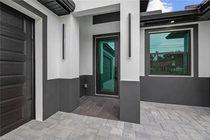 Entrance to property featuring stucco siding