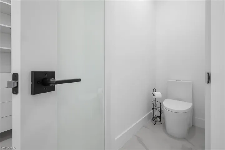 Bathroom featuring baseboards and marble finish floors