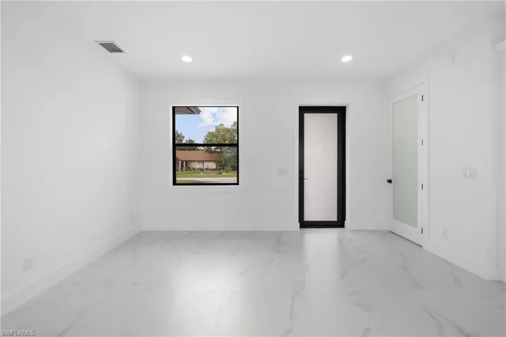 Spare room featuring recessed lighting and light marble finish floors