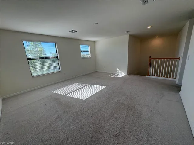 Spare room featuring carpet floors and recessed lighting