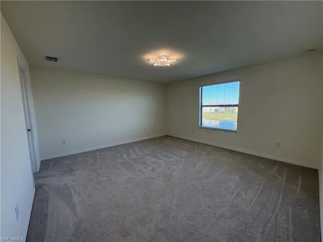 Spare room with carpet floors and baseboards