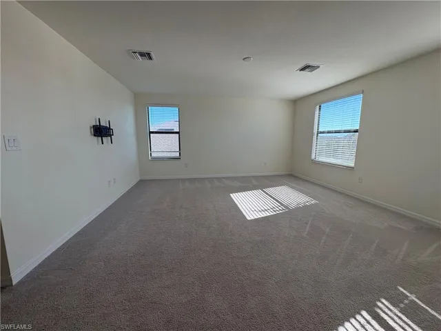 Empty room featuring carpet floors and baseboards