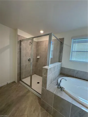 Full bath with a garden tub and a shower stall