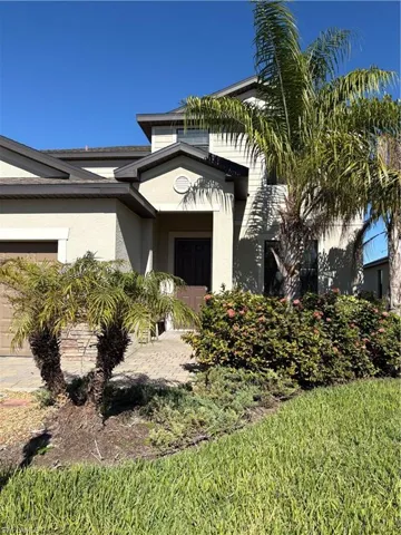 Entrance to property featuring stucco siding and an attached garage
