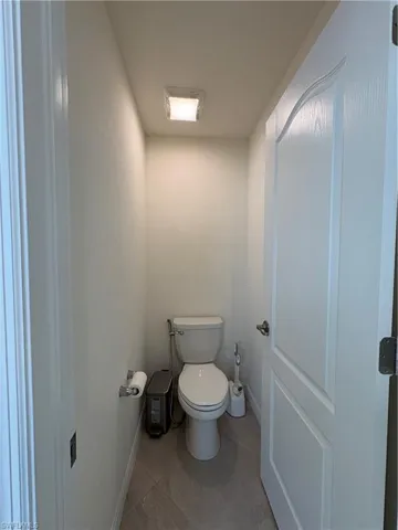 Bathroom featuring toilet and light tile patterned floors