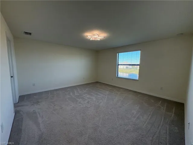 Spare room with carpet floors and baseboards