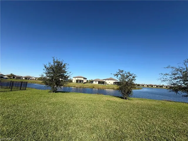 View of yard featuring a water view and a residential view