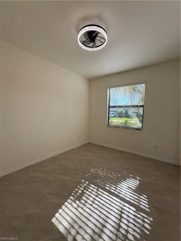 Unfurnished room featuring baseboards