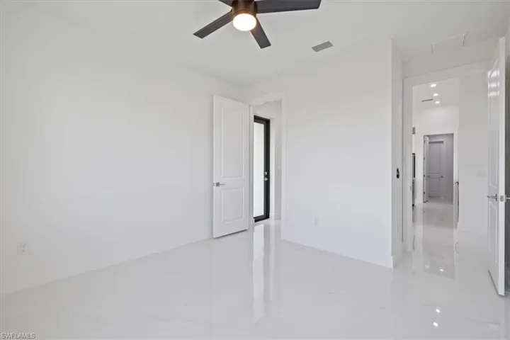 Unfurnished bedroom featuring light marble finish floors, a ceiling fan, and recessed lighting