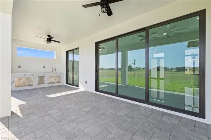View of patio / terrace featuring an outdoor kitchen and ceiling fan