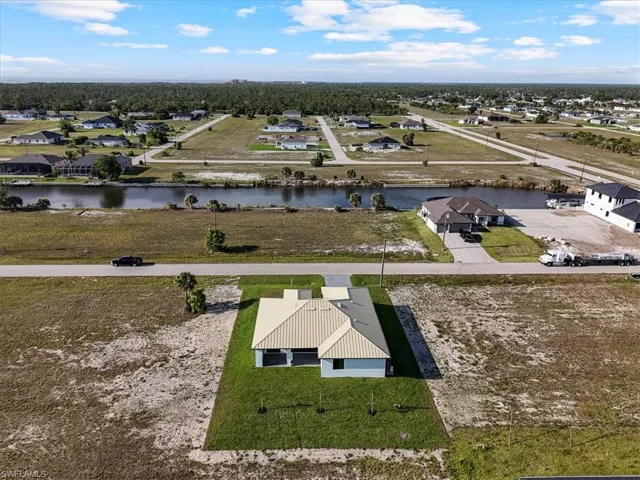 Aerial perspective of suburban area featuring a nearby body of water