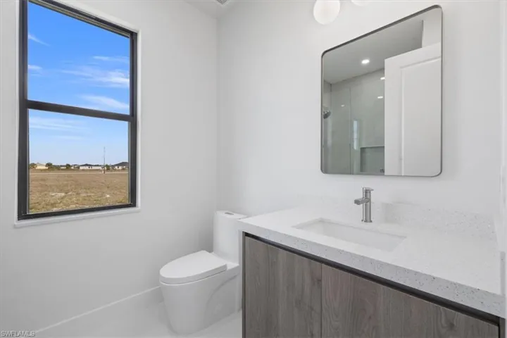 Bathroom featuring vanity and a shower