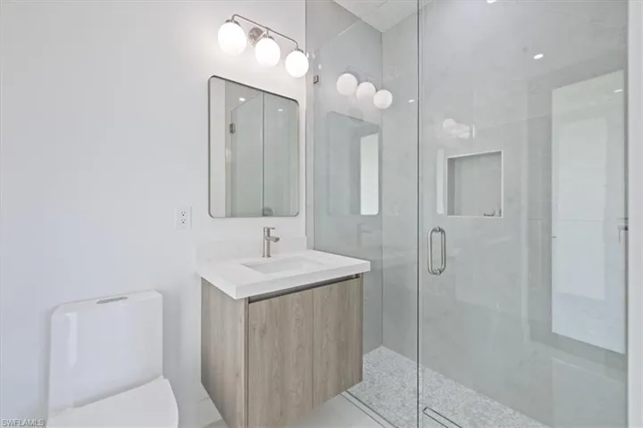 Bathroom with vanity and a stall shower