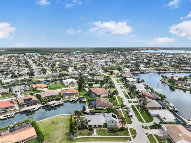 Aerial perspective of suburban area with a nearby body of water