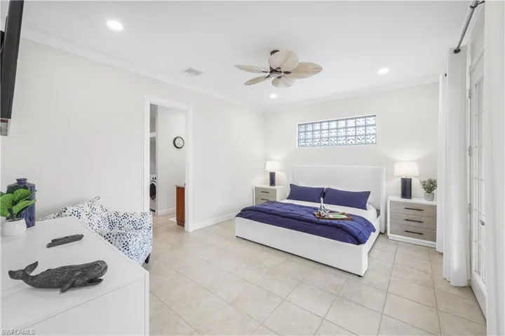 Bedroom featuring light tile patterned floors, crown molding, washer / clothes dryer, recessed lighting, and ceiling fan