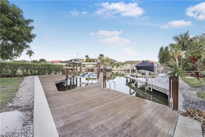 Dock featuring boat lift and a water view