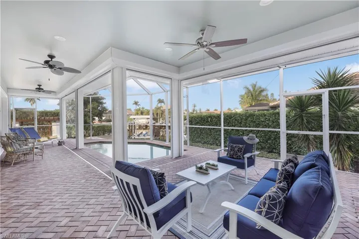 Sunroom with a ceiling fan, an outdoor hangout area, and healthy amount of natural light