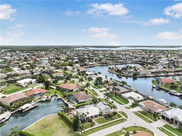 Aerial overview of property's location featuring nearby suburban area and a large body of water