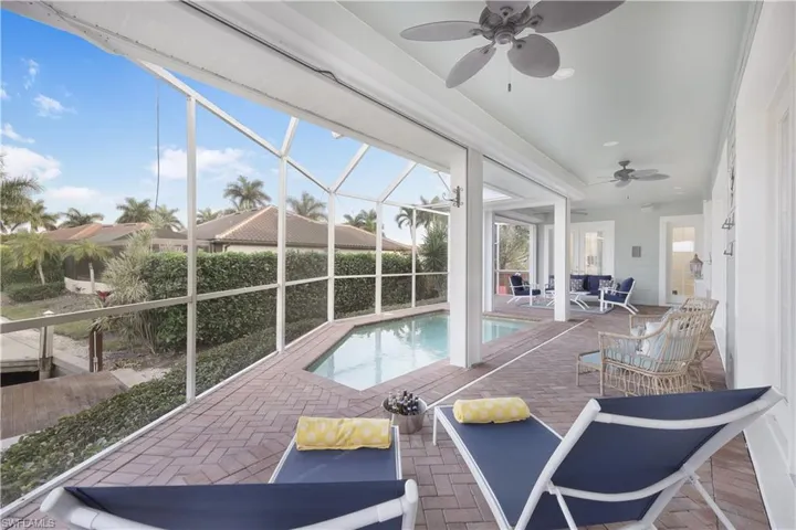 View of pool featuring ceiling fan, a patio area, a lanai, and an outdoor hangout area
