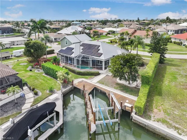 Aerial perspective of suburban area featuring a nearby body of water
