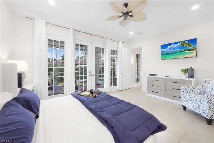 Bedroom with french doors, light tile patterned floors, access to outside, recessed lighting, and ceiling fan