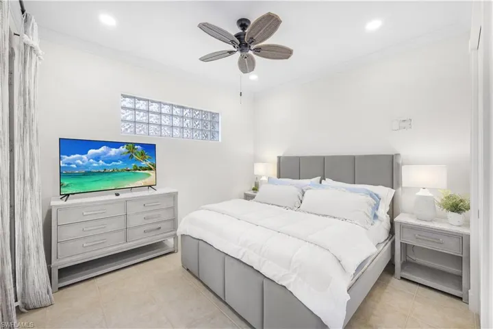 Bedroom with crown molding, light tile patterned floors, recessed lighting, and a ceiling fan