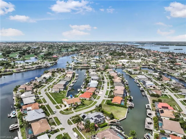 Aerial view of property's location featuring nearby suburban area and a nearby body of water