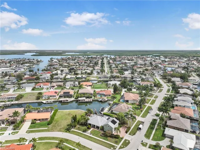 Aerial view of property and surrounding area with nearby suburban area and a nearby body of water
