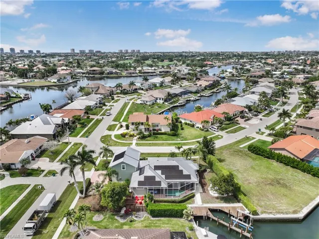 Aerial view of property's location with nearby suburban area and a large body of water