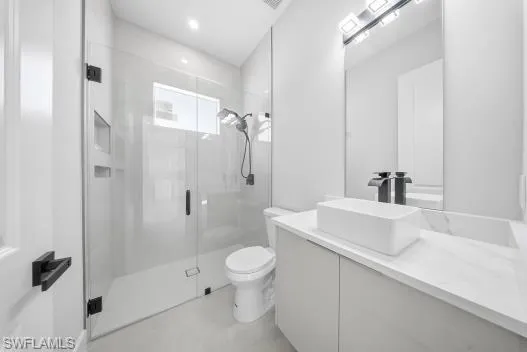 Bathroom with a stall shower and vanity