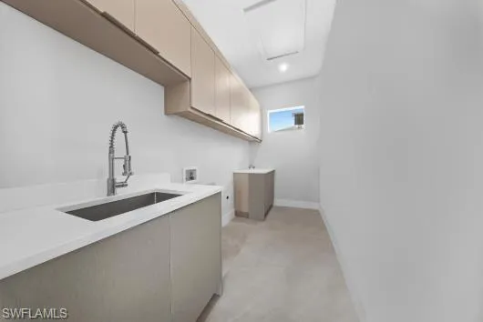 Laundry area featuring cabinet space, hookup for a washing machine, and light colored carpet