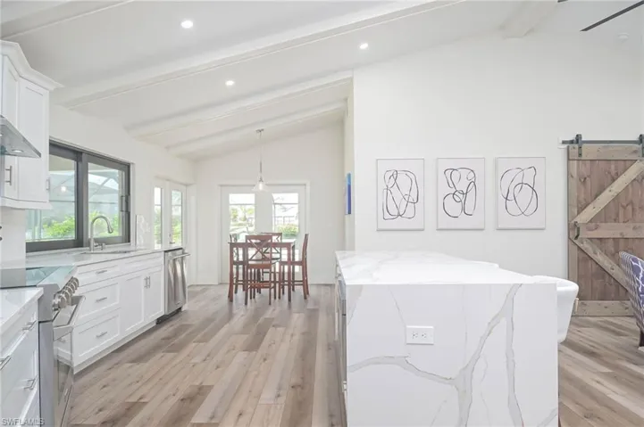Casual dining area!  Sliders above kitchen sink and FRENCH DOORS for easy access to the POOL area!