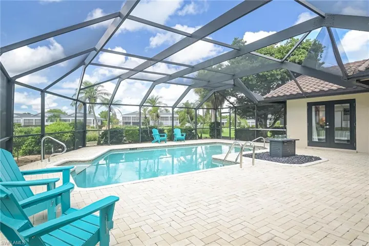 Spacious pool area accented with brick pavers and newer screens!