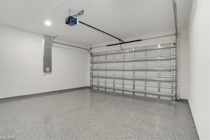 Garage with electric panel and a garage door opener