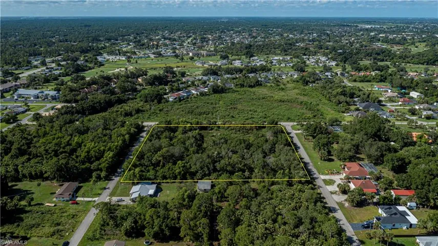 View of property location featuring property boundaries highlighted and  wooded area