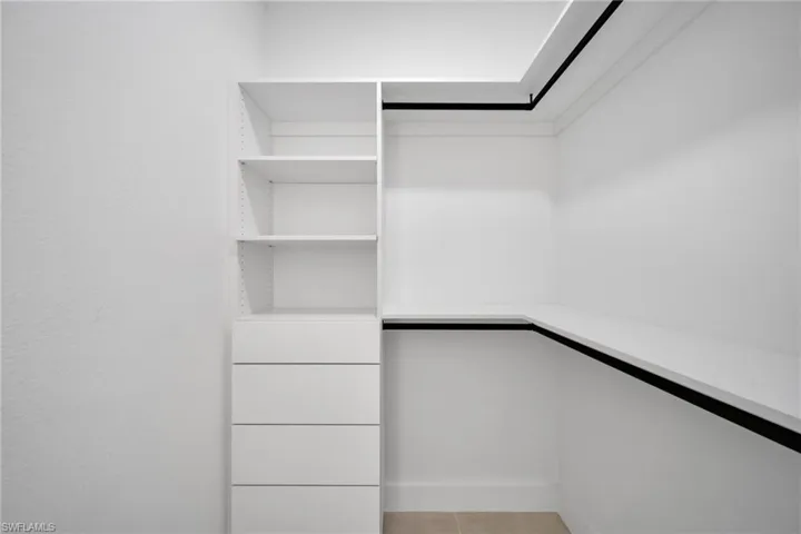 Spacious closet featuring light tile patterned flooring