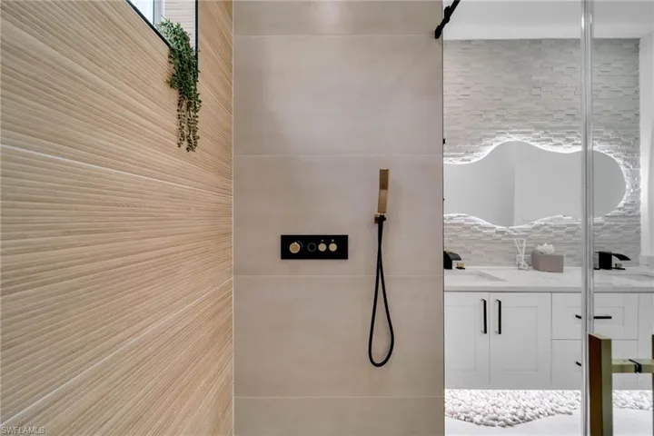 Full bath featuring vanity and a tile shower