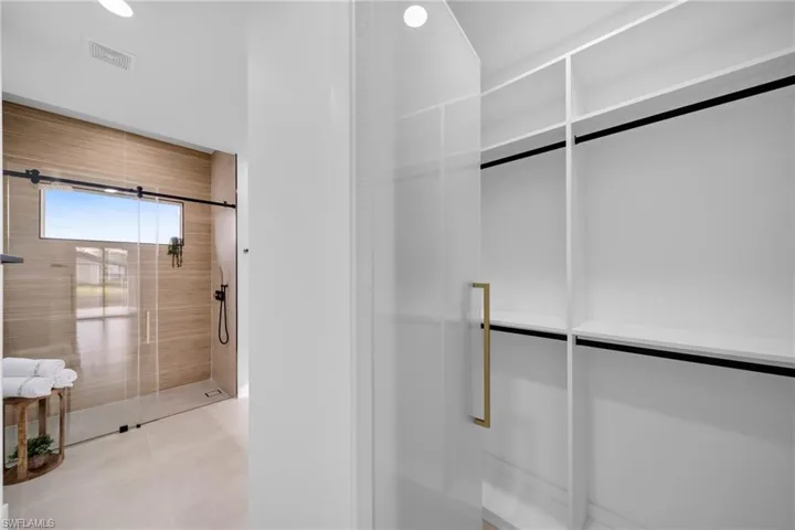 Bathroom with visible vents and walk in shower