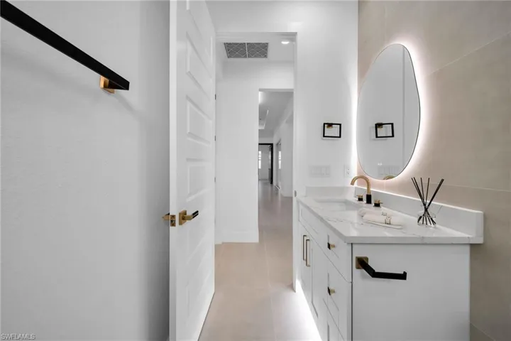 Bathroom featuring tile patterned floors, visible vents, and vanity