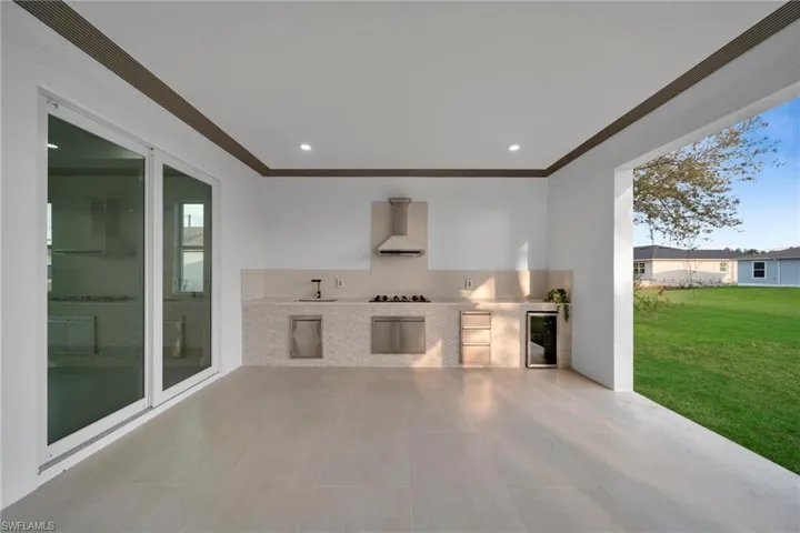 View of patio / terrace with an outdoor kitchen and beverage cooler
