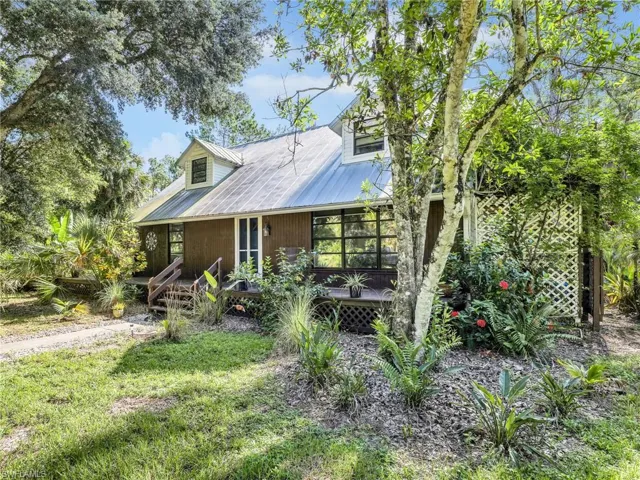 View of front of home featuring covered porch and a metal roof