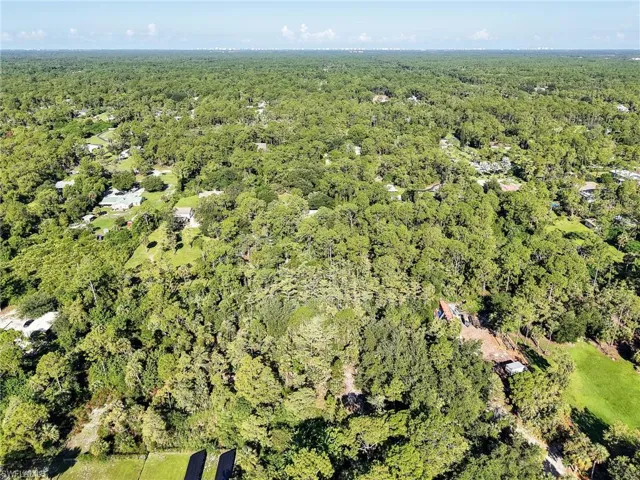Aerial view of property's location with a forest