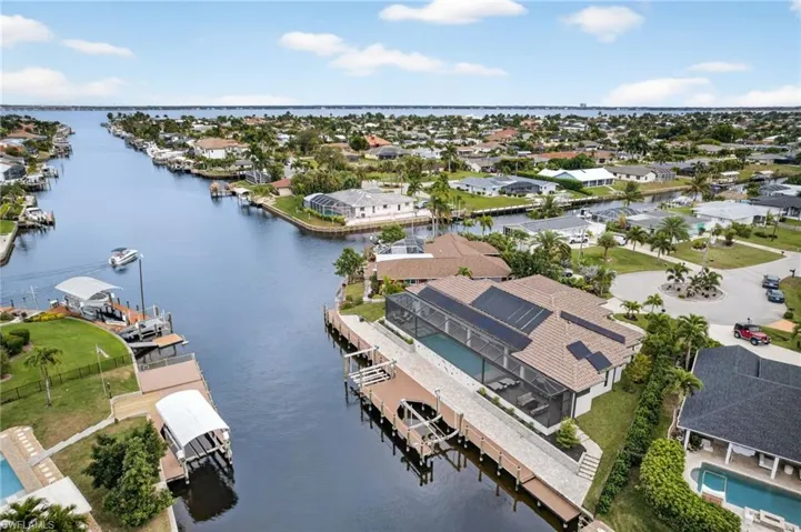 Aerial perspective of suburban area featuring a nearby body of water