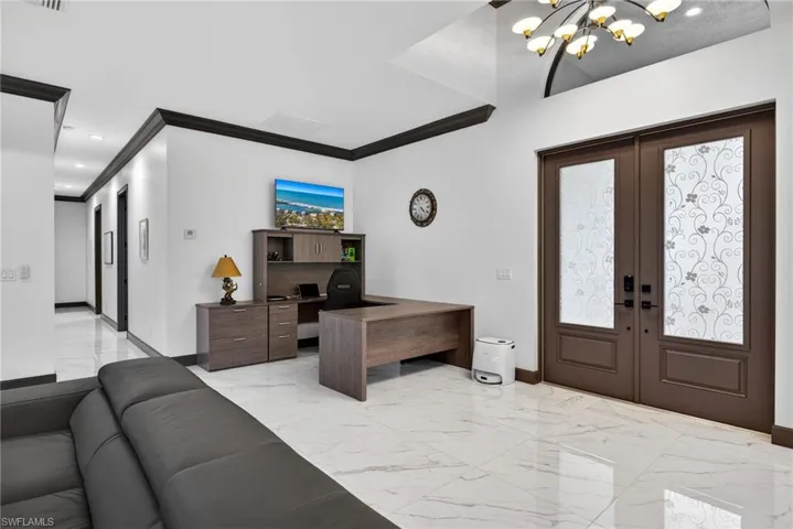 Foyer featuring light marble finish floors, french doors, crown molding, a chandelier, and recessed lighting