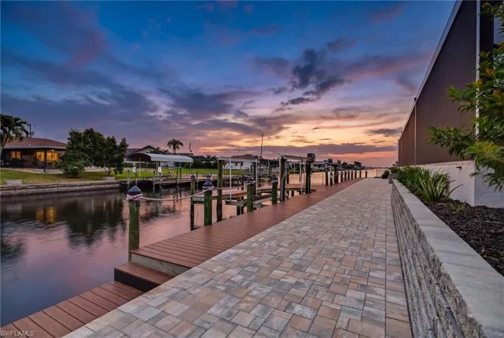 Dock area featuring boat lift and a water view
