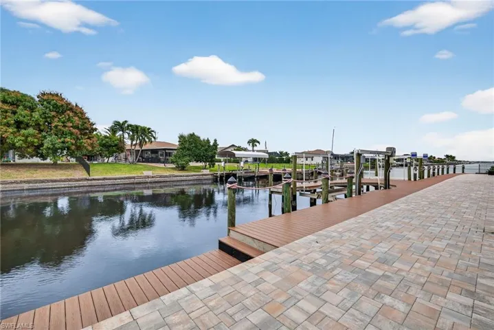 Dock featuring boat lift and a water view